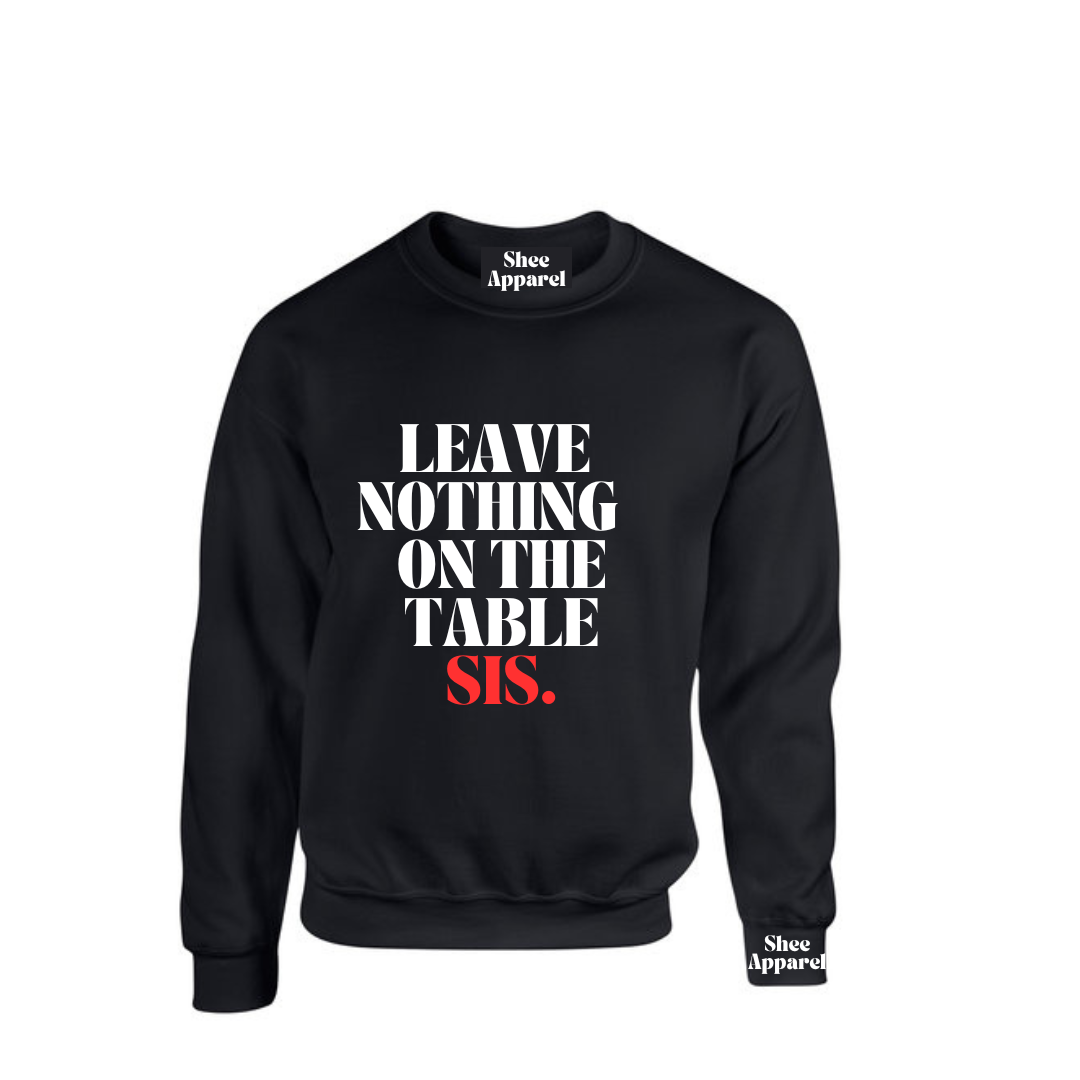 Model wearing the SheeApparel® Leave Nothing on the Table, Sis™ black crewneck sweatshirt featuring bold white and red affirmation text