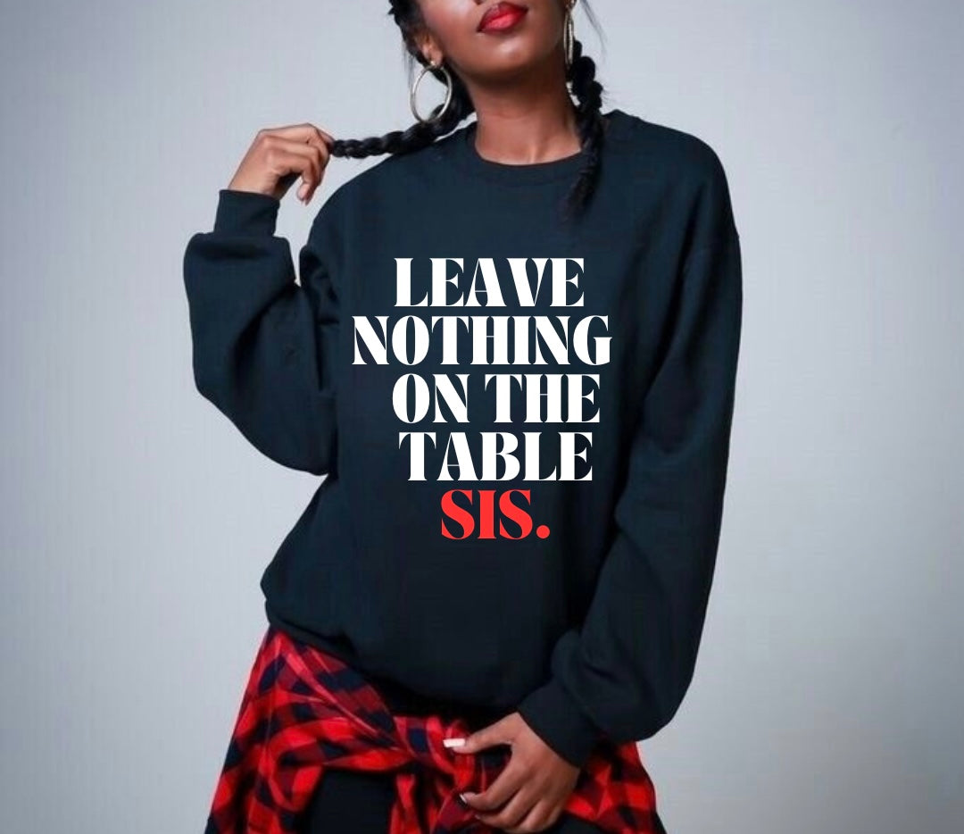 Model wearing the SheeApparel® Leave Nothing on the Table, Sis™ black crewneck sweatshirt featuring bold white and red affirmation text