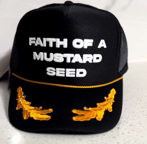 Black cap with 'Faith of a Mustard Seed' text and mustard seed designs on a white background